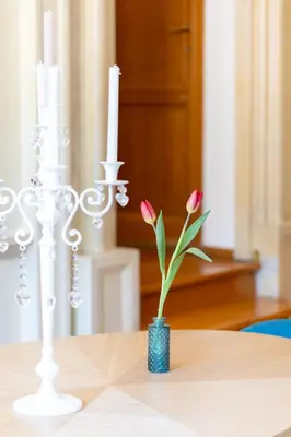 a vase with pink flowers sitting on a table at MB SUITES Margutta in Rome