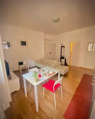 a living room with a white table and a couch at I-LARI Apartment in Rome