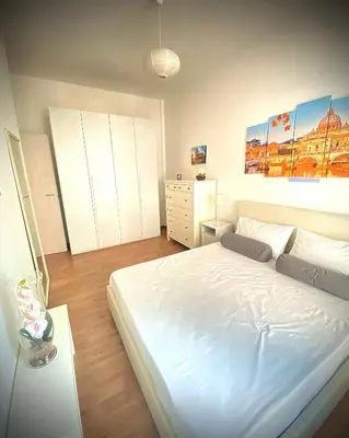 a bedroom with a large white bed in it at I-LARI Apartment in Rome