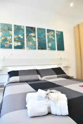 a room with three beds with towels on them at Roma Clodio Holiday in Rome