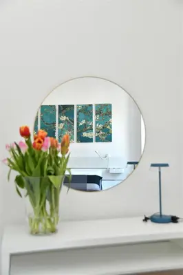 a vase of flowers on a counter with a mirror at Roma Clodio Holiday in Rome