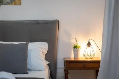 a bedroom with a bed and a table with a lamp at Angelico By Rental in Rome in Rome