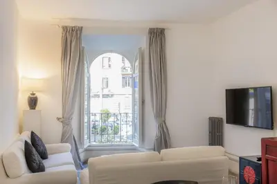 a living room with two white couches and a window at Angelico By Rental in Rome in Rome