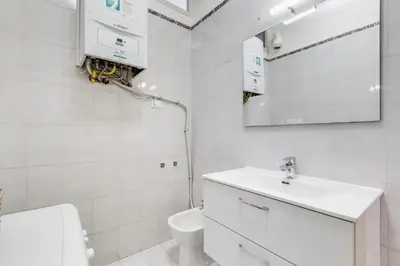 a white bathroom with a sink and a toilet at AM House Colosseo in Rome
