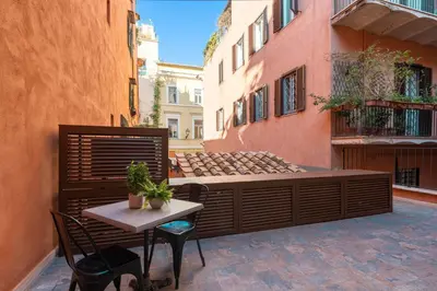 a patio with a table and chairs in a courtyard at Palazzetto Symphony in Rome