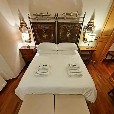 a bedroom with a large bed with two towels on it at 1878s by SC LUXURY HISTORIC HOUSE PIAZZA DI SPAGNA in Rome
