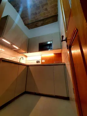 an overhead view of a kitchen with a microwave at 1878s by SC LUXURY HISTORIC HOUSE PIAZZA DI SPAGNA in Rome