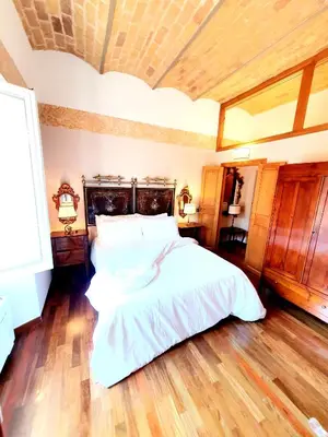 a bedroom with a large white bed and wooden floors at 1878s by SC LUXURY HISTORIC HOUSE PIAZZA DI SPAGNA in Rome