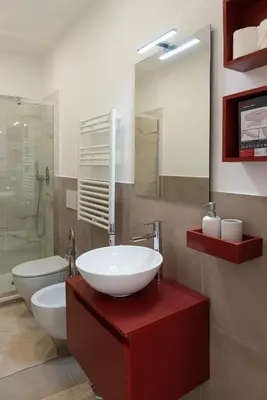 a bathroom with a sink and a toilet and a mirror at Designer Apartment Via Nazionale in Rome
