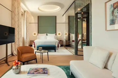 a living room with a television and a bed at Bvlgari Hotel Roma in Rome