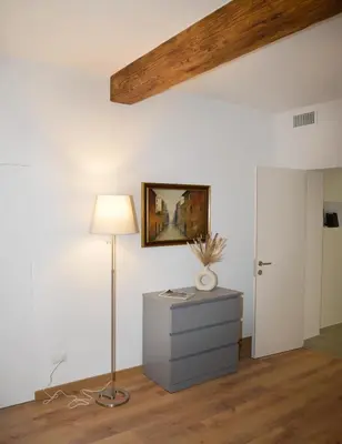 a room with a lamp and a painting on the wall at Fidia Palace Claudia's apartment Colosseo in Rome