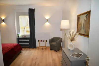 a bedroom with a bed and a chair and a window at Fidia Palace Claudia's apartment Colosseo in Rome