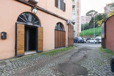 a building with wooden doors on a street at Trastevere Loft in Rome