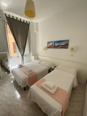 a room with three beds and a window at GUEST HOUSE FIDARDO in Rome