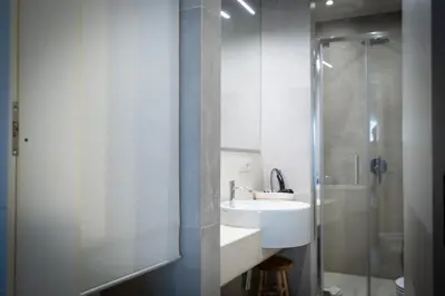 a bathroom with a sink and a shower at HT Luxury Altare della Patria in Rome