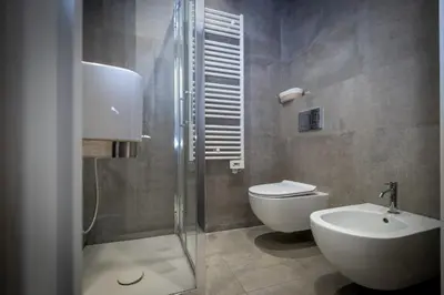 a bathroom with a shower and a toilet and a sink at HT Luxury Altare della Patria in Rome