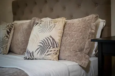 a group of pillows sitting on a bed at HT Luxury Altare della Patria in Rome