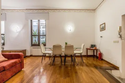 a living room with a table and chairs at Casa Ghetto 13 in Rome