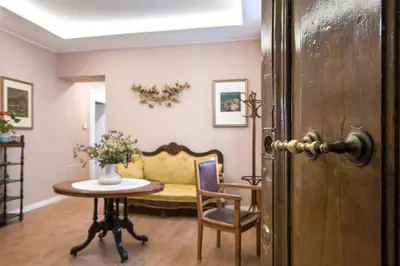 a living room with a table and a couch at Elegante grande appartamento con 4 stanze - Vaticano e centro Roma in Rome