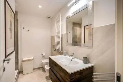 a bathroom with a sink and a toilet and a mirror at suity I cozy leutari 23 in Rome