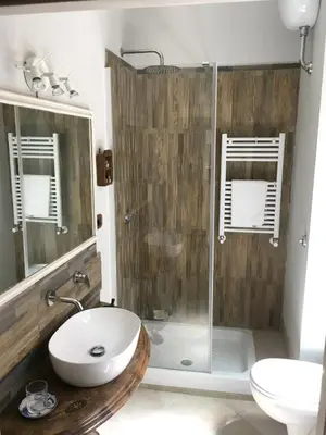 a bathroom with a shower and a sink and a toilet at Foscari Holiday House in Rome