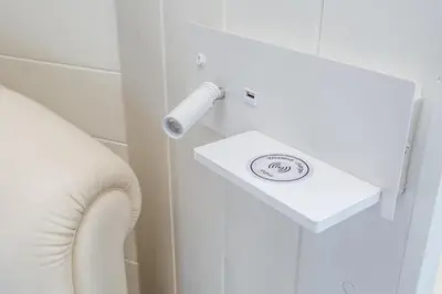a bathroom with a white sink and a white chair at the B rooftop apartment in Rome