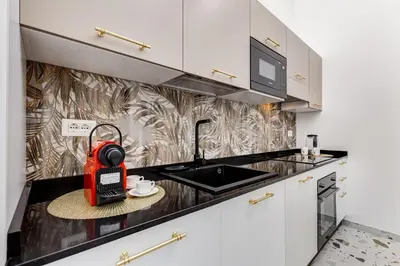 a kitchen with a red appliance on a counter at Villa Chiara - a new Luxury Star is born in Rome! in Rome