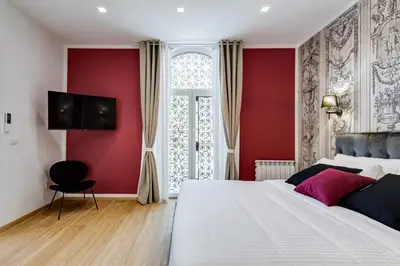 a bedroom with a white bed and red walls at Villa Chiara - a new Luxury Star is born in Rome! in Rome