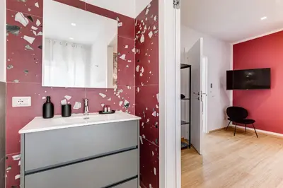a bathroom with a sink and a red wall with butterflies at Villa Chiara - a new Luxury Star is born in Rome! in Rome
