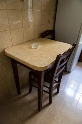 a table in a kitchen with two chairs around it at Alexander Vatican House in Rome