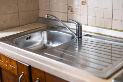a kitchen sink with two faucets on top of it at Alexander Vatican House in Rome