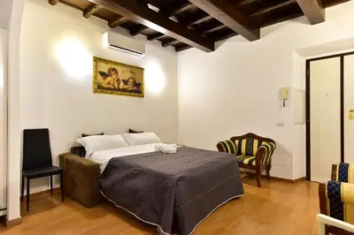 a bedroom with a bed and a chair at Elite Rome apartments 3 in Rome