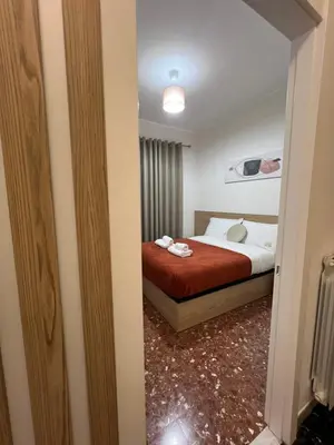 a bedroom with a bed with a red blanket at Casa Arya in Rome