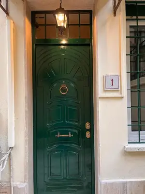 a green door with a light on top of it at Loft Villa Blanc in Rome