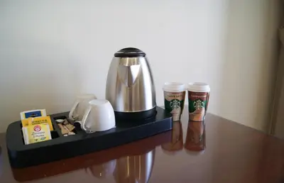 a tray with a coffee maker and two cups on a table at Glam Luxury Rome in Rome