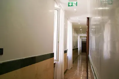 a hallway of a building with a window and a corridor at Glam Luxury Rome in Rome