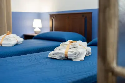 two beds with towels sitting on top of them at HolidayHomeNazzarena in Rome