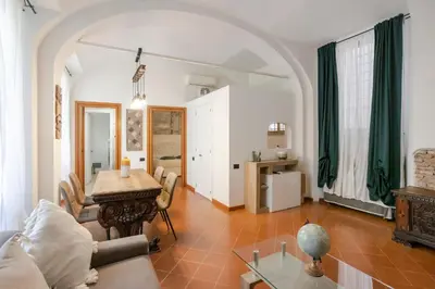 a living room with a table and a couch at Home d'Elite Trevi Fountain in Rome