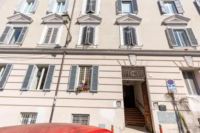 a large white building with windows and a door at The 62 Home l Homkeey Apartments in Rome