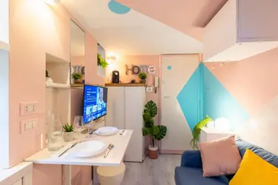 a bathroom with a sink and a couch in a room at The 62 Home l Homkeey Apartments in Rome