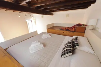 a bedroom with a bed with two towels on it at Borgo Comfortable Loft in Rome