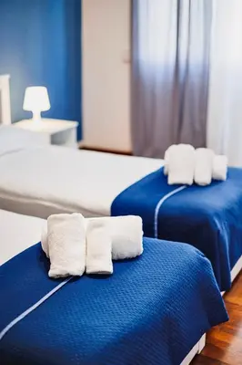 two beds with towels on them in a room at Monferrato Home in Rome
