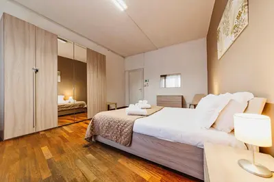 a bedroom with a large white bed in a room at Monferrato Home in Rome