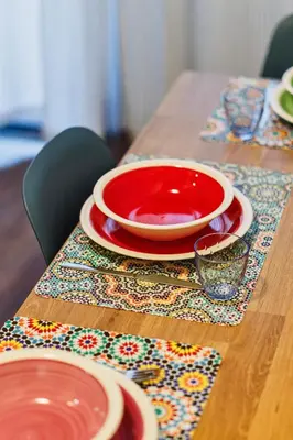 a wooden table with red bowls and plates on it at Monferrato Home in Rome